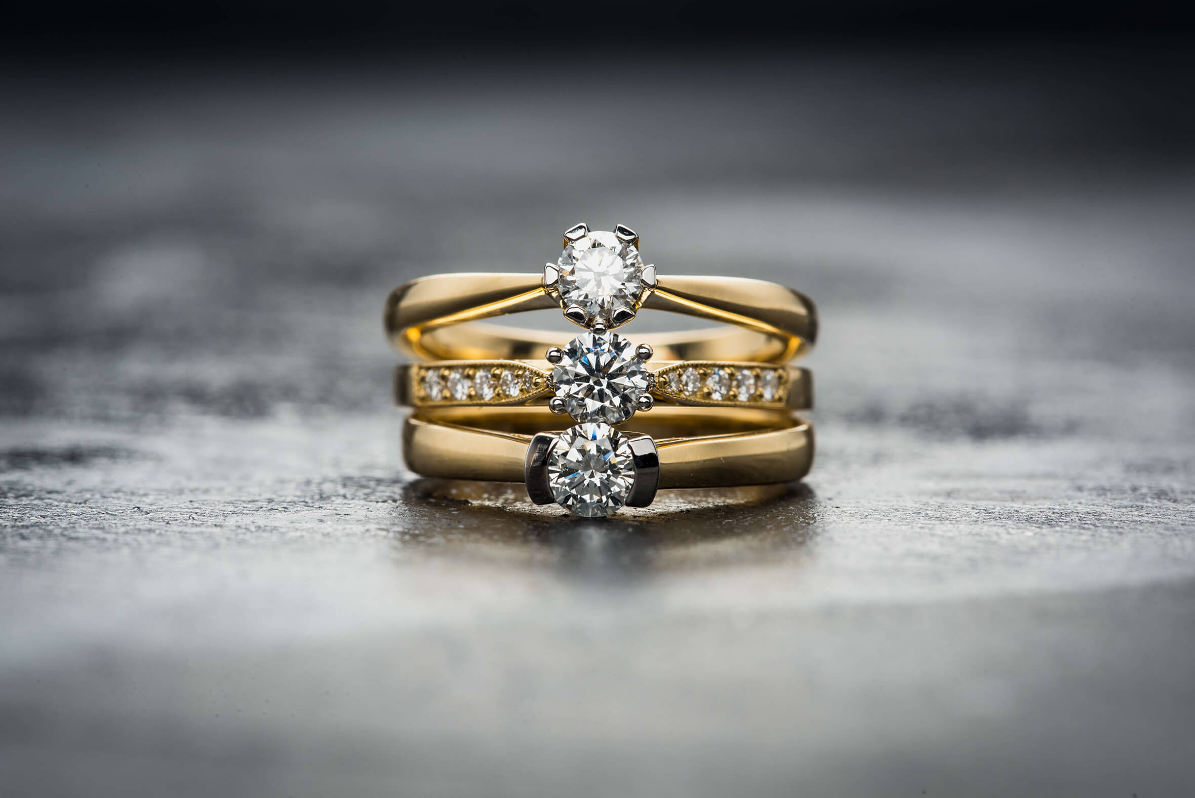 A pair of diamond rings on a stone surface